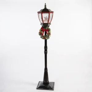 Farol navideño negro con corona decorativa iluminada